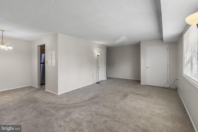 3811 Swann Rd Unit T-3, Suitland, MD 20746 - spare room with a textured ceiling, carpet floors, a chandelier, and baseboards