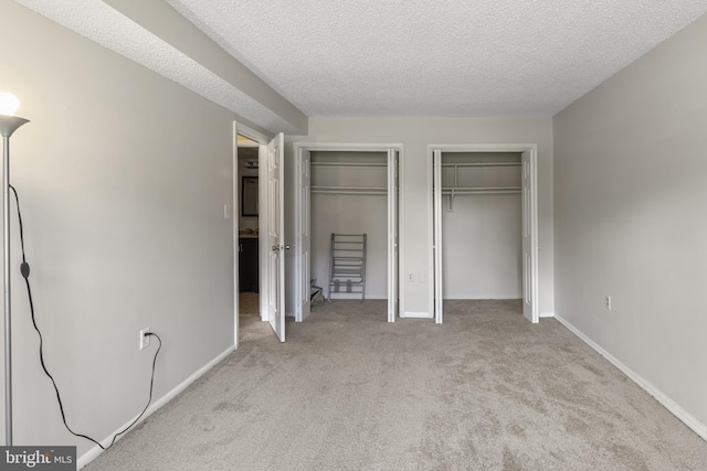 3811 Swann Rd Unit T-3, Suitland, MD 20746 - unfurnished bedroom with carpet floors, multiple closets, a textured ceiling, and baseboards