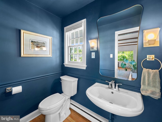 9103 Chickawane Ct, Alexandria, VA 22309 - bathroom with a baseboard heating unit, toilet, a sink, baseboards, and wood finished floors