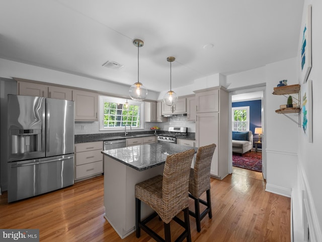 9103 Chickawane Ct, Alexandria, VA 22309 - kitchen with appliances with stainless steel finishes, light wood-style flooring, a sink, tasteful backsplash, and gray cabinets