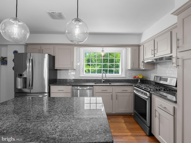 9103 Chickawane Ct, Alexandria, VA 22309 - kitchen featuring appliances with stainless steel finishes, a sink, tasteful backsplash, under cabinet range hood, and decorative light fixtures