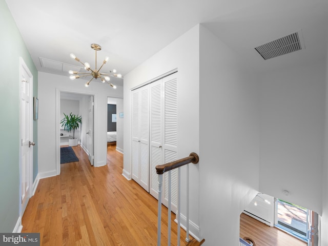 9103 Chickawane Ct, Alexandria, VA 22309 - hall featuring an upstairs landing, light wood-style flooring, a chandelier, and baseboards