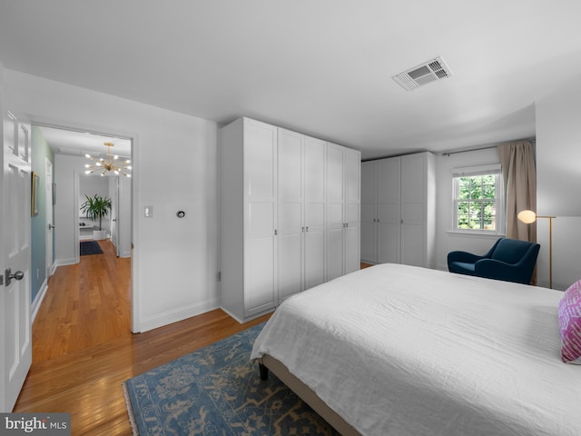 9103 Chickawane Ct, Alexandria, VA 22309 - bedroom with a chandelier, light wood-style floors, and baseboards