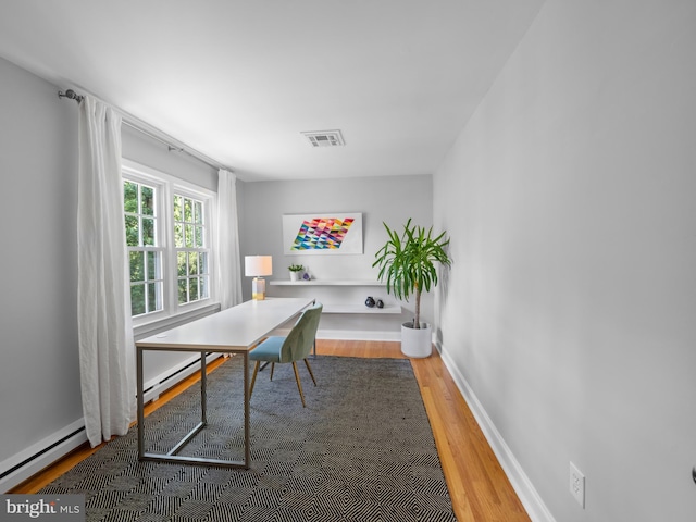 9103 Chickawane Ct, Alexandria, VA 22309 - office space featuring a baseboard heating unit, wood finished floors, and baseboards