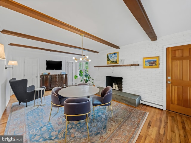 9103 Chickawane Ct, Alexandria, VA 22309 - dining area with beam ceiling, a brick fireplace, a baseboard heating unit, wood finished floors, and a chandelier