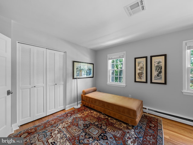 9103 Chickawane Ct, Alexandria, VA 22309 - bedroom with a baseboard heating unit, wood finished floors, a closet, and baseboards