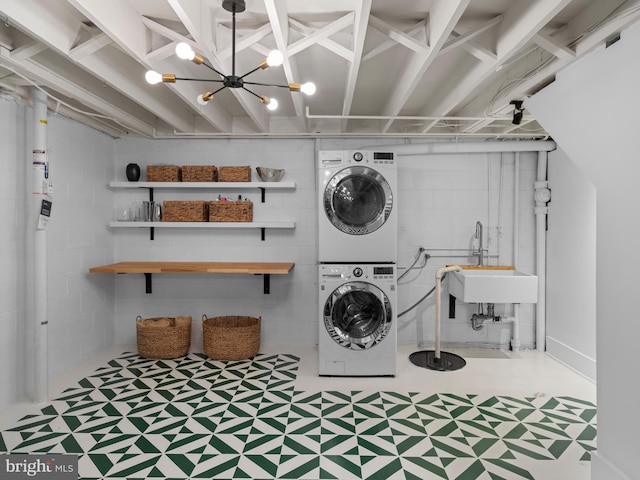 9103 Chickawane Ct, Alexandria, VA 22309 - laundry area featuring stacked washer / dryer, tile patterned floors, and a chandelier