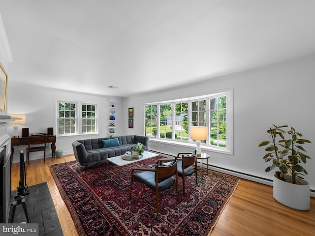 9103 Chickawane Ct, Alexandria, VA 22309 - living area featuring wood finished floors, a baseboard radiator, a fireplace with flush hearth, and ornamental molding