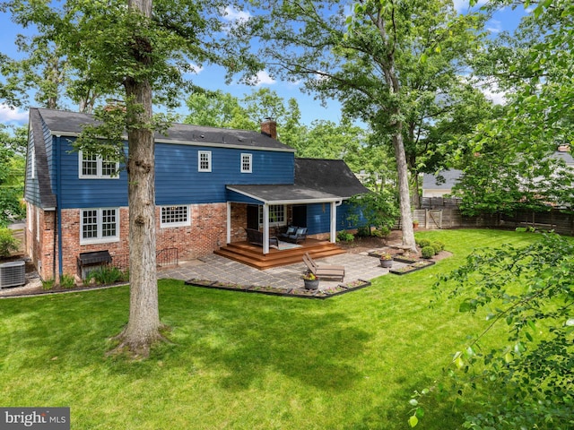 9103 Chickawane Ct, Alexandria, VA 22309 - rear view of property featuring brick siding, a chimney, a patio area, central AC unit, and a wooden deck