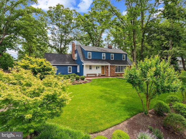 9103 Chickawane Ct, Alexandria, VA 22309 - view of front of house featuring a chimney, a front lawn, and a porch