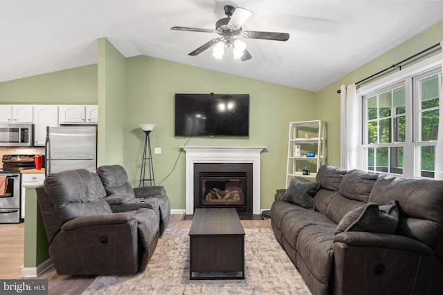1971 High Top Rd, Linden, VA 22642 - living area with light wood-type flooring, vaulted ceiling, ceiling fan, and a glass covered fireplace