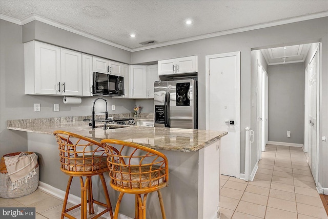 425 Robin Dr Unit 302, Ocean City, MD 21842 - kitchen featuring black microwave, stainless steel fridge, light tile patterned floors, a peninsula, and ornamental molding