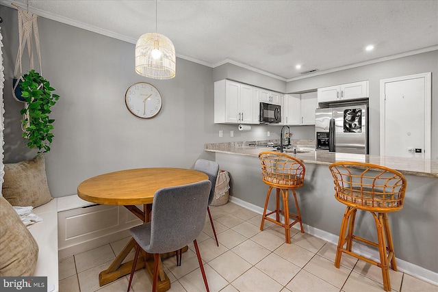425 Robin Dr Unit 302, Ocean City, MD 21842 - kitchen featuring black microwave, stainless steel fridge, ornamental molding, light countertops, and white cabinetry