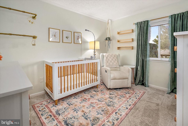 425 Robin Dr Unit 302, Ocean City, MD 21842 - bedroom featuring ornamental molding, carpet flooring, a nursery area, baseboards, and a textured ceiling