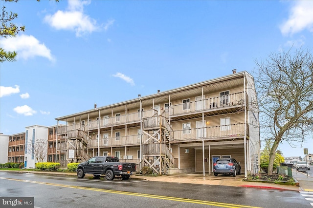 425 Robin Dr Unit 302, Ocean City, MD 21842 - view of apartment building / complex with stairs and covered parking