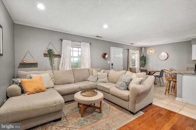 425 Robin Dr Unit 302, Ocean City, MD 21842 - living room with crown molding, recessed lighting, a textured ceiling, and light wood-style flooring