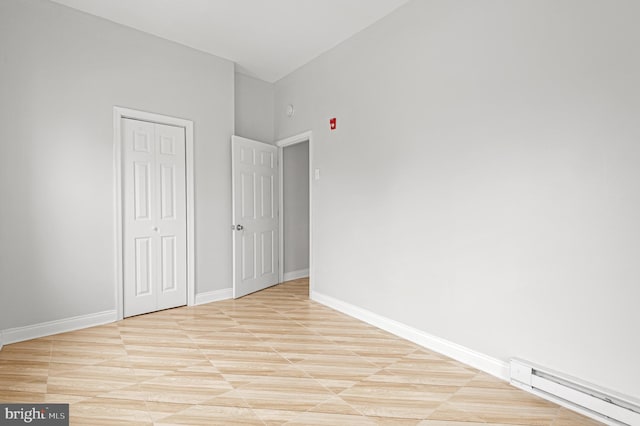 755 S 22nd St, Philadelphia, PA 19146 - unfurnished bedroom with baseboard heating, a closet, baseboards, and a high ceiling
