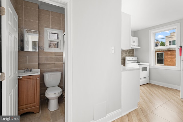 755 S 22nd St, Philadelphia, PA 19146 - bathroom featuring vanity, toilet, tile patterned flooring, baseboards, and tile walls