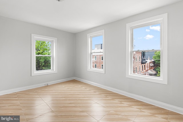 755 S 22nd St, Philadelphia, PA 19146 - empty room with healthy amount of natural light, baseboards, and light tile patterned floors