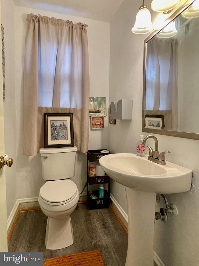 1506 Mcgovern Ter, Wilmington, DE 19805 - half bathroom featuring wood finished floors, toilet, and baseboards