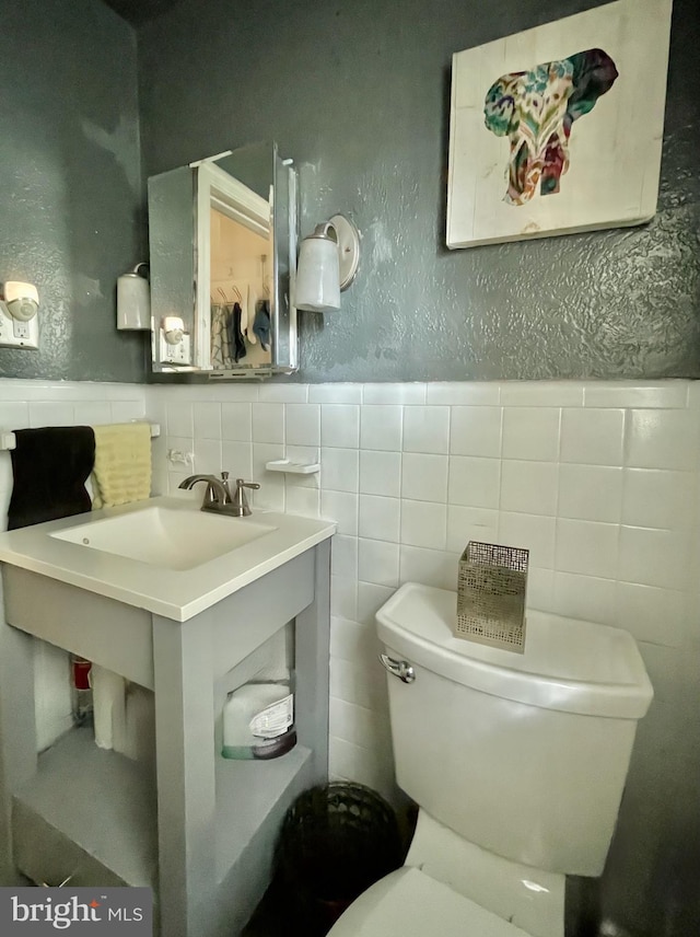1506 Mcgovern Ter, Wilmington, DE 19805 - bathroom featuring tile walls, toilet, a textured wall, and wainscoting