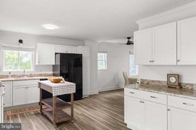 1164 Fairfax Pike, White Post, VA 22663 - kitchen featuring black refrigerator with ice dispenser, a sink, white cabinets, light wood-type flooring, and crown molding