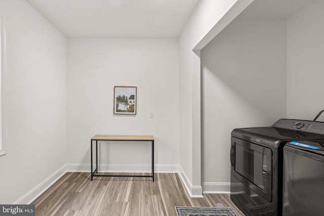1164 Fairfax Pike, White Post, VA 22663 - laundry area with washer and clothes dryer, wood finished floors, and baseboards