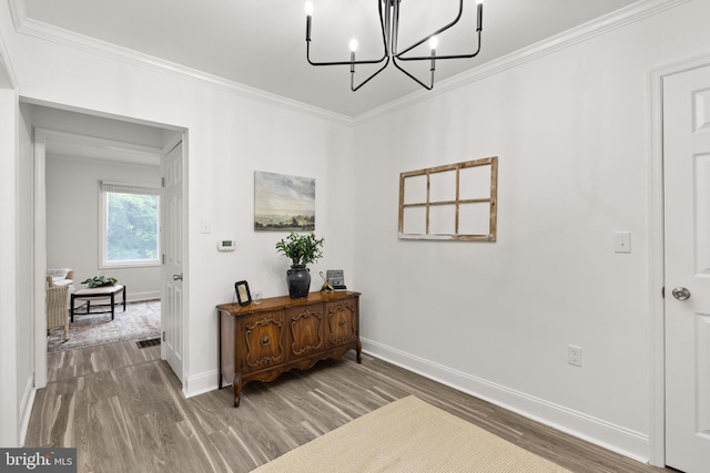 1164 Fairfax Pike, White Post, VA 22663 - hall featuring wood finished floors, crown molding, baseboards, and a chandelier