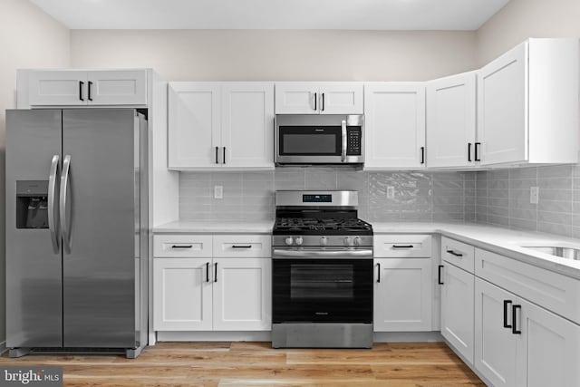 1728 S Bancroft St, Philadelphia, PA 19145 - kitchen with stainless steel appliances, light countertops, and white cabinets