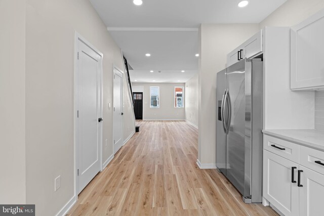 1728 S Bancroft St, Philadelphia, PA 19145 - kitchen with stainless steel refrigerator with ice dispenser, light wood-style floors, white cabinets, light countertops, and recessed lighting