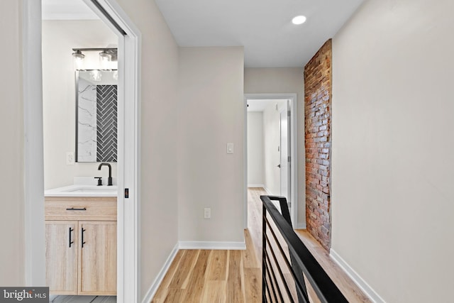 1728 S Bancroft St, Philadelphia, PA 19145 - corridor featuring a sink, light wood-style flooring, and baseboards