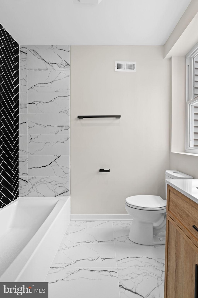 1728 S Bancroft St, Philadelphia, PA 19145 - bathroom featuring vanity, marble finish floors, toilet, baseboards, and bathtub / shower combination
