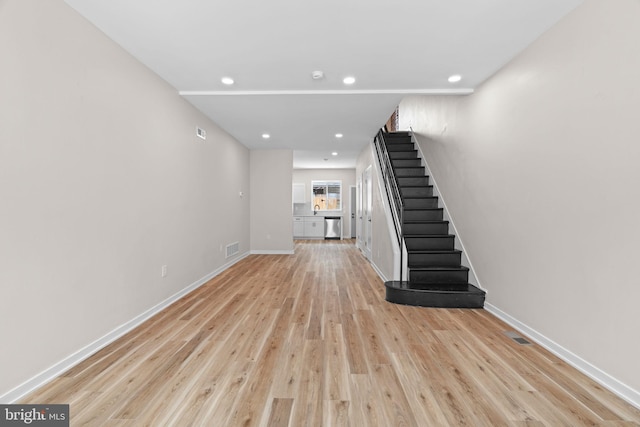 1728 S Bancroft St, Philadelphia, PA 19145 - unfurnished living room with stairway, light wood-style floors, baseboards, and recessed lighting