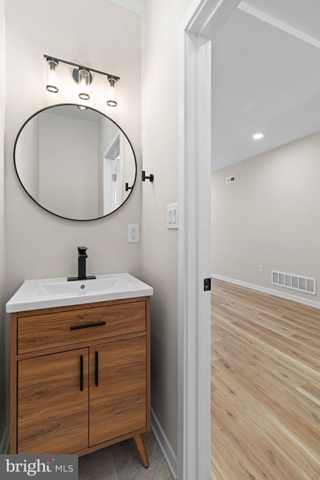 1728 S Bancroft St, Philadelphia, PA 19145 - bathroom with vanity, baseboards, and wood finished floors