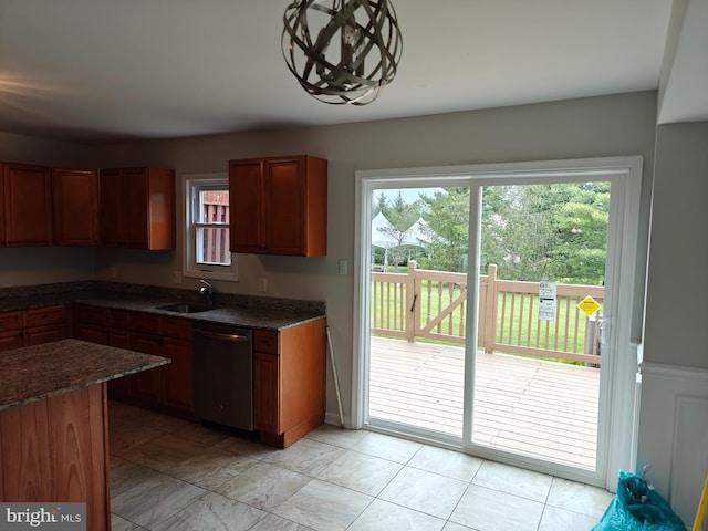 3910 Gatehouse Ln, Skippack, PA 19474 - kitchen featuring stainless steel dishwasher, dark stone countertops, brown cabinetry, and a sink