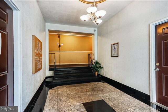 116 Lee Ave Unit 112, Takoma Park, MD 20912 - corridor featuring granite floors and a chandelier