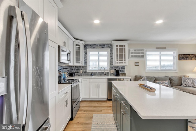 6801 Atlantic Ave Unit 2, Ocean City, MD 21842 - kitchen with stainless steel appliances, a sink, ornamental molding, light countertops, and light wood finished floors