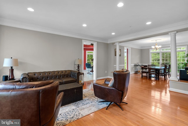 8800 Primula Dr, Laytonsville, MD 20882 - living area with decorative columns, light wood finished floors, a chandelier, crown molding, and recessed lighting