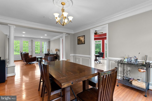 8800 Primula Dr, Laytonsville, MD 20882 - dining area with ornate columns, crown molding, light wood-type flooring, a wainscoted wall, and a chandelier