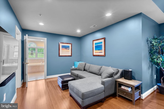 8800 Primula Dr, Laytonsville, MD 20882 - living room featuring baseboards, light wood-style flooring, and recessed lighting