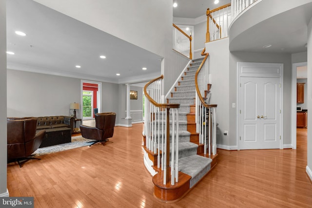 8800 Primula Dr, Laytonsville, MD 20882 - stairs featuring ornamental molding, wood finished floors, baseboards, recessed lighting, and a high ceiling