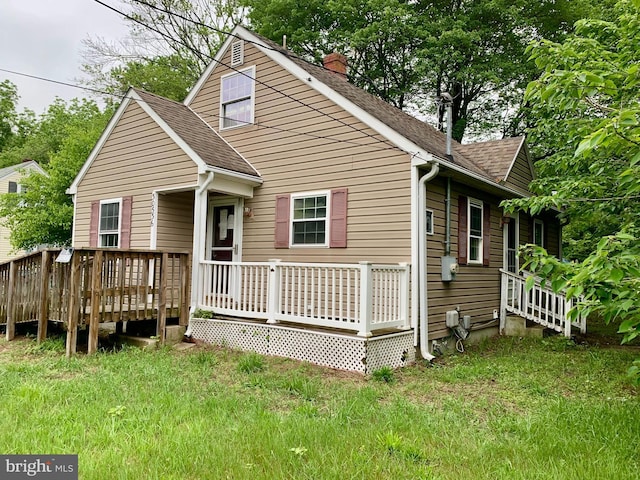 30536 Bennett Rd, Salisbury, MD 21804 - bungalow-style house with a shingled roof, a chimney, a wooden deck, and a front lawn