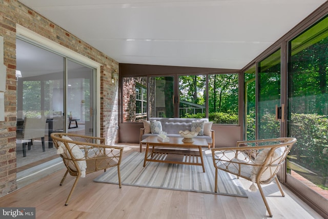 1334 Elsinore Ave, Mclean, VA 22102 - sunroom / solarium with brick wall, wood finished floors, and plenty of natural light