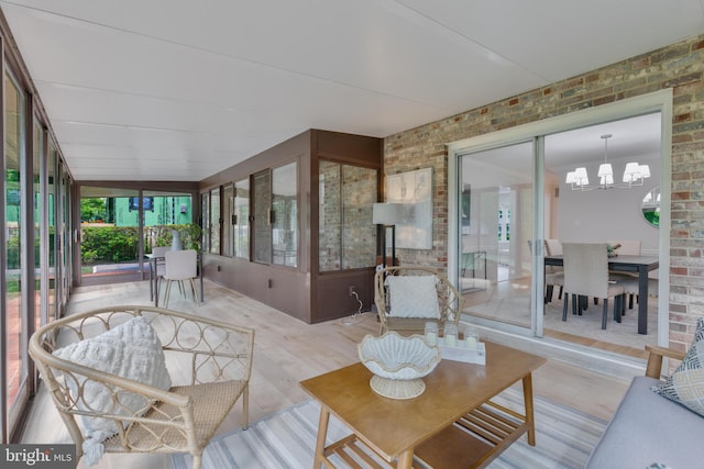 1334 Elsinore Ave, Mclean, VA 22102 - sunroom with brick wall, wood finished floors, and a chandelier