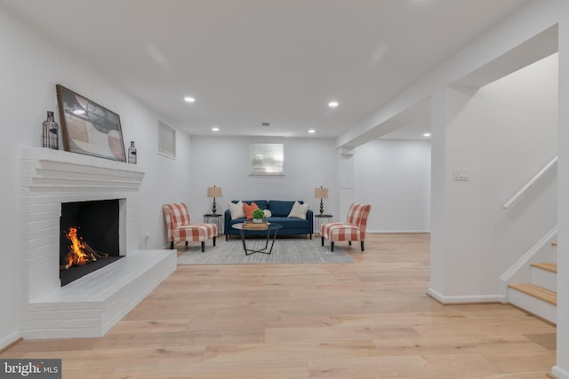 1334 Elsinore Ave, Mclean, VA 22102 - living area with stairway, light wood finished floors, recessed lighting, a brick fireplace, and baseboards