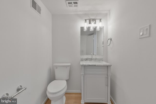 1334 Elsinore Ave, Mclean, VA 22102 - half bathroom featuring toilet, vanity, baseboards, and wood finished floors