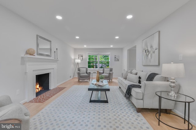 1334 Elsinore Ave, Mclean, VA 22102 - living room with light wood-style floors, a warm lit fireplace, recessed lighting, and baseboards