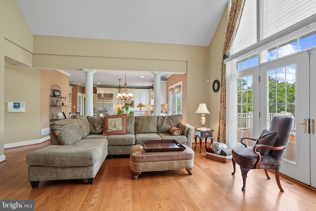 2860 Pfefferkorn Rd, West Friendship, MD 21794 - living room featuring decorative columns, healthy amount of natural light, a chandelier, light wood finished floors, and high vaulted ceiling