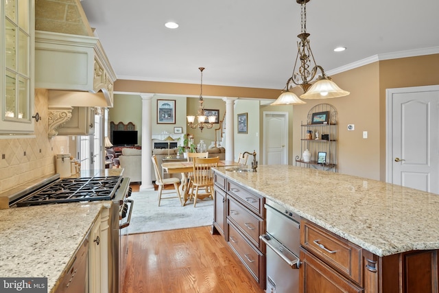 2860 Pfefferkorn Rd, West Friendship, MD 21794 - kitchen with decorative columns, stainless steel gas stove, light wood-style floors, glass insert cabinets, and light stone countertops