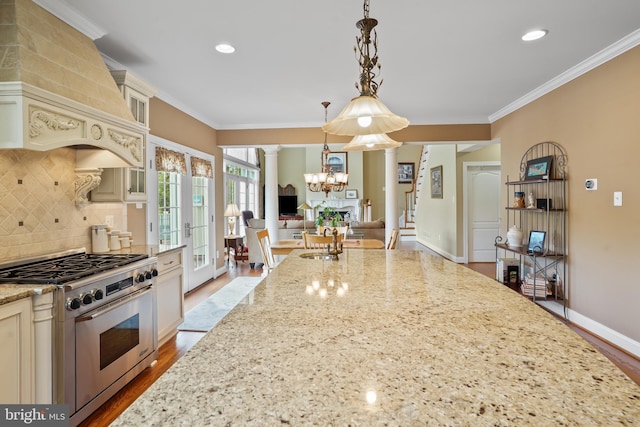 2860 Pfefferkorn Rd, West Friendship, MD 21794 - kitchen featuring stainless steel stove, cream cabinetry, decorative columns, custom exhaust hood, and ornamental molding